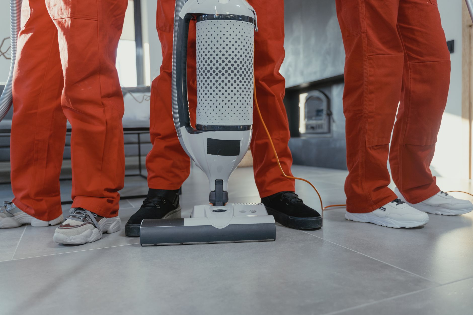 Crew sanitizing a large commercial floor with an industrial scrubber